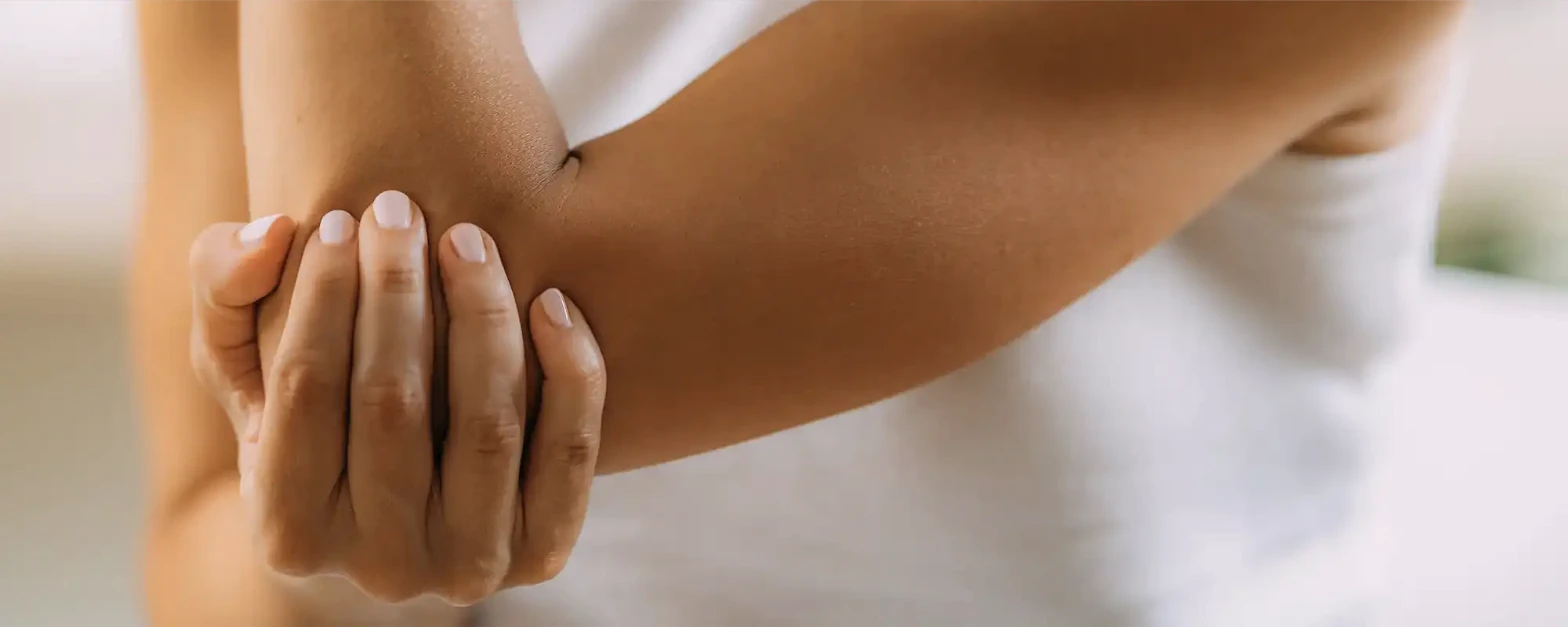 Physical therapist assessing a patient's elbow and wrist mobility