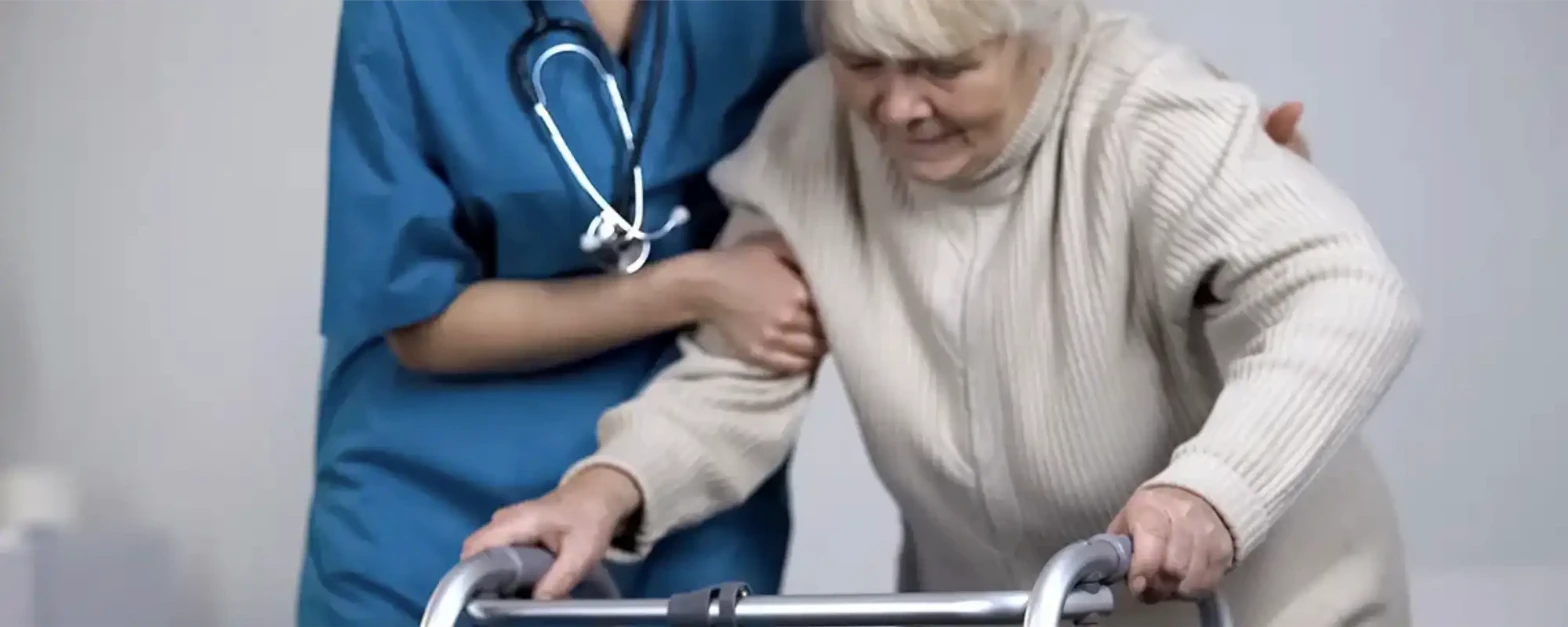 Physical therapist guiding a patient's hip replacement recovery exercises