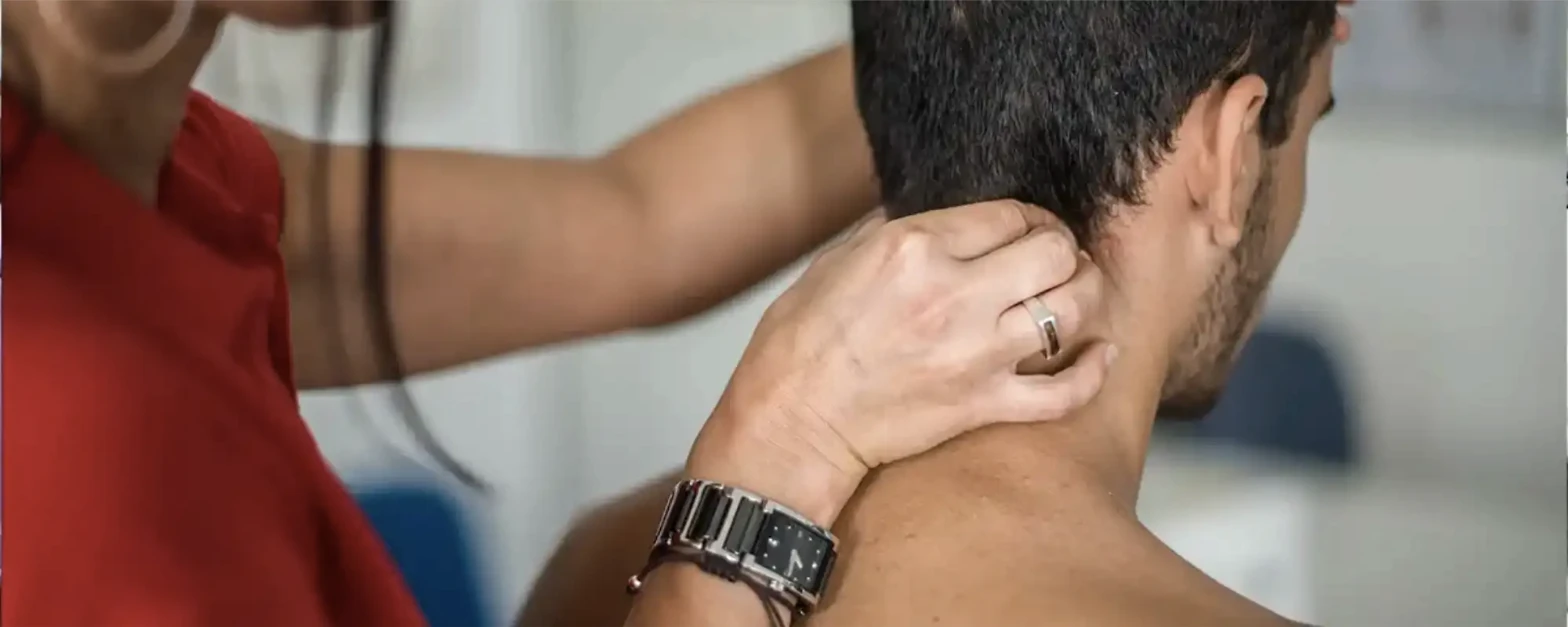 Physical therapist assessing a patient's neck mobility