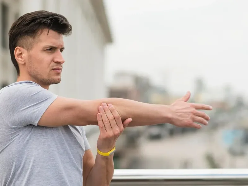 A person stretching outdoors, back to full activity