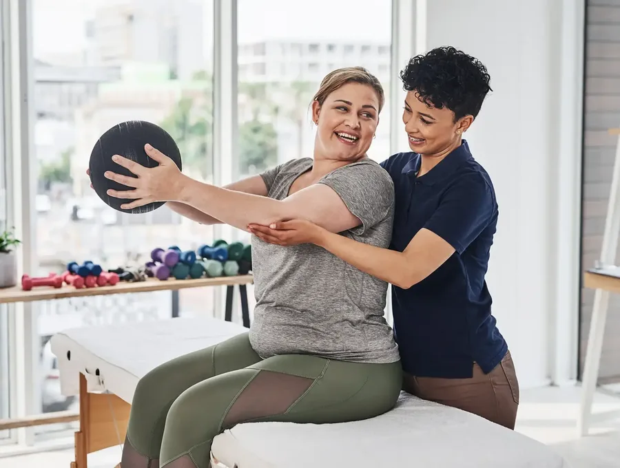 Physical therapist guiding a patient through a one-on-one session