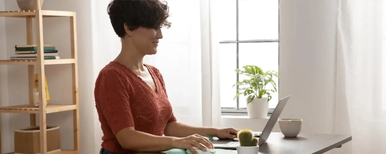Person working at an ergonomic home workstation setup
