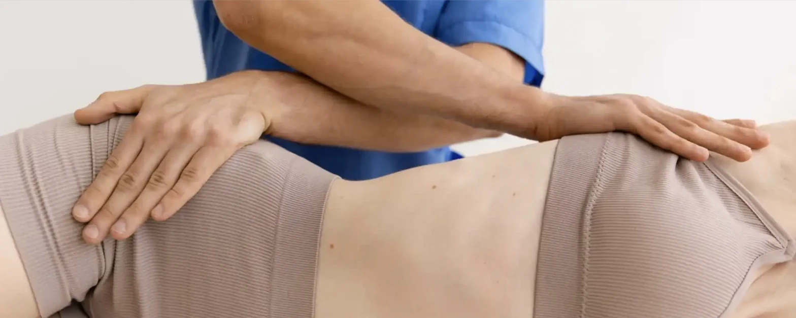 Clinician performing manual therapy osteopathy session on a patient