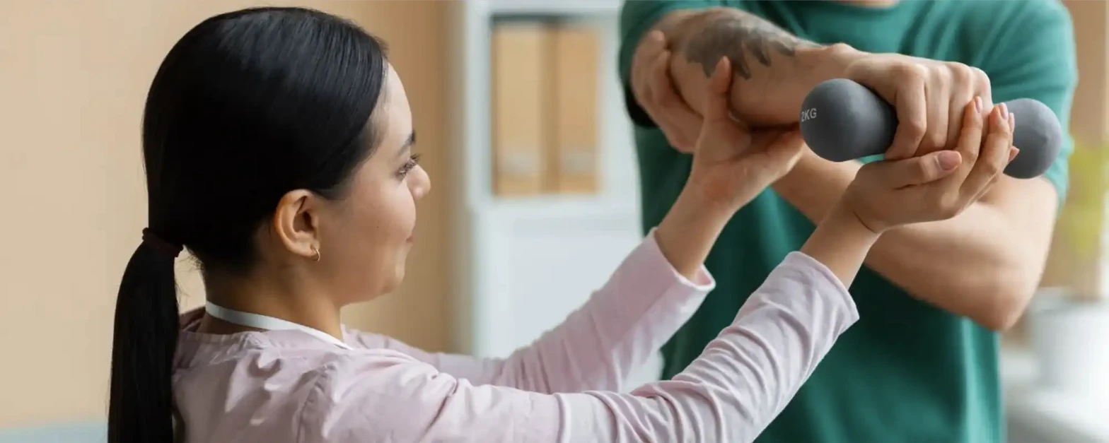Doctor helping a patient with repetitive stress rehabilitation exercises